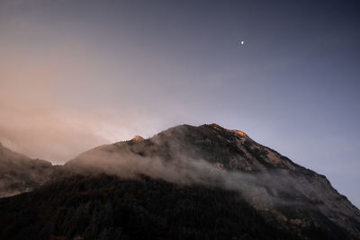 Low angle view of volcanic mountain against sky