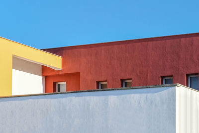 Low angle view of building against clear blue sky