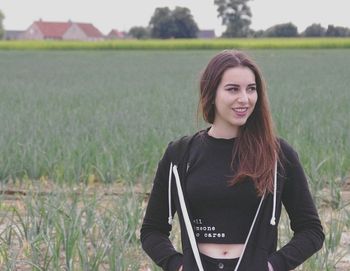 Young woman standing on field