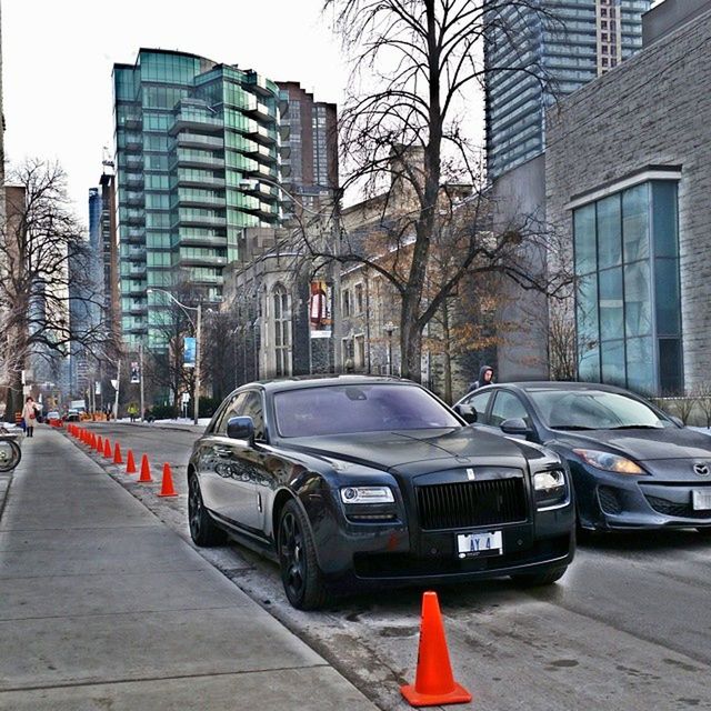 building exterior, car, transportation, architecture, built structure, land vehicle, street, city, mode of transport, road, city street, city life, road marking, building, stationary, parking, bare tree, day, tree, parked