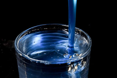 Close-up of glass of water against black background