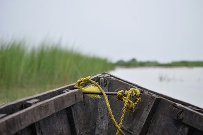 Close-up of rope on boat against lake