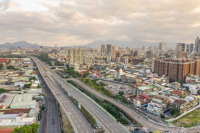 High angle view of street amidst buildings in city against sky