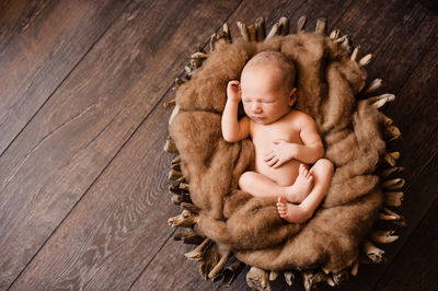 High angle view of baby sleeping on floor