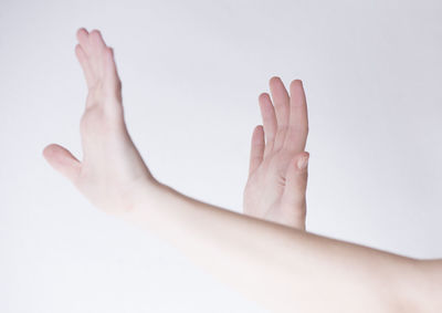 Low section of person legs against white background