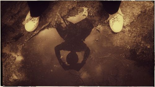 Low section of woman standing on tiled floor