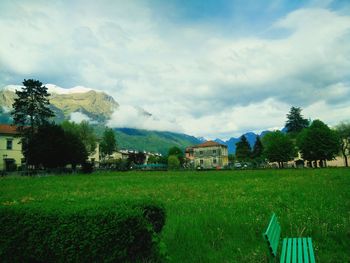 Scenic view of grassy field against cloudy sky