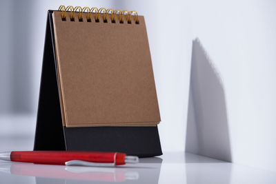 Close-up of open book on table against white background