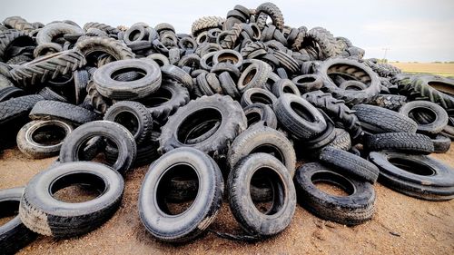 Heap of damaged tires on field