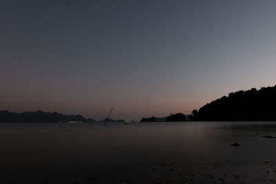 Scenic view of sea against clear sky at sunset