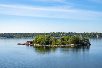 Idyllic scenery of houses on island of archipelago amidst baltic sea against sky