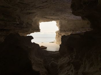 Scenic view of sea seen through cave