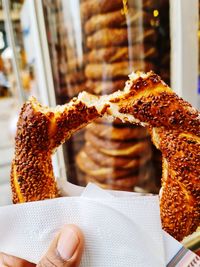 Cropped hand of person holding food