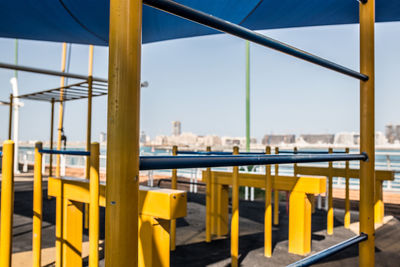 Close-up of yellow table against clear sky