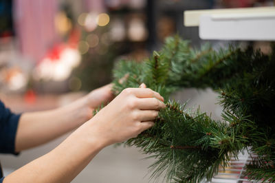 Midsection of woman with christmas tree