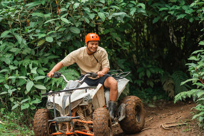 Side view of young man working on field