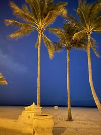 Low angle view of coconut palm trees against sky