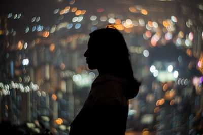 Woman standing at night