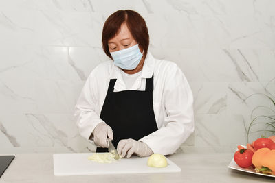 Midsection of woman holding ice cream while standing on table