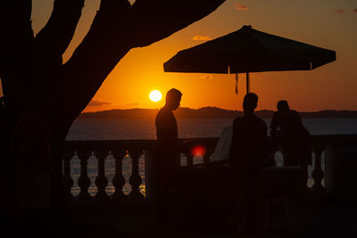 Silhouette of people against the sunset.