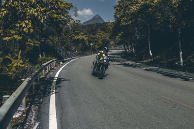 Man riding bicycle on road