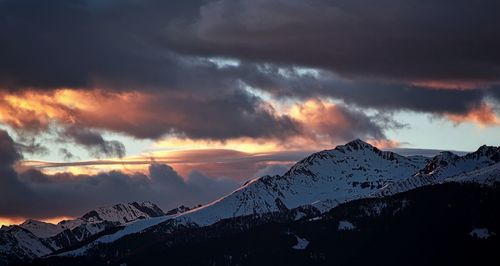 Scenic view of snowcapped mountains against sky during sunset