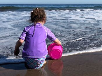 Rear view of woman on beach