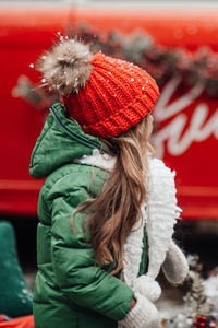 Rear view of girl with christmas tree