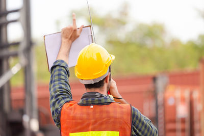 Rear view of man working at construction site