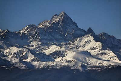 Scenic view of snowcapped mountains against clear sky