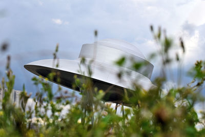 Blurred motion of traditional windmill on field against sky