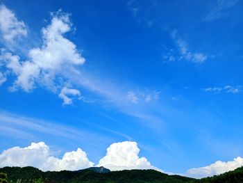 Low angle view of clouds over blue sky