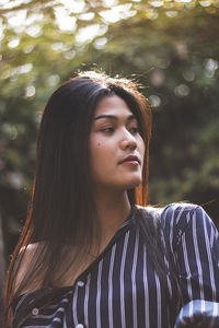 Close-up of young woman looking away