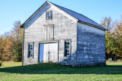 Exterior of house on field against sky