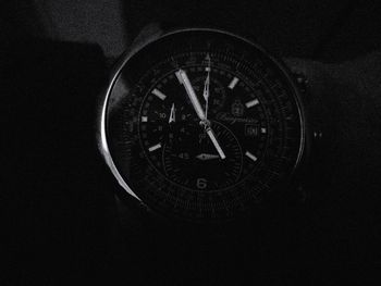 Close-up of clock against black background