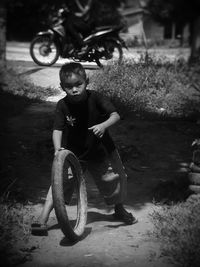 Portrait of boy playing with bicycle