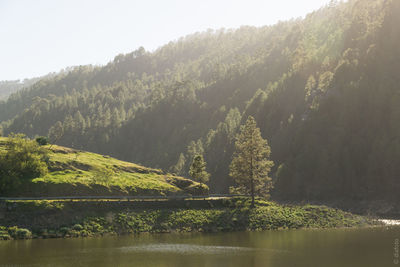 Scenic view of lake and mountains against sky