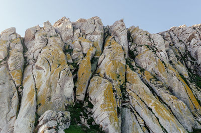 Low angle view of rock formation against sky