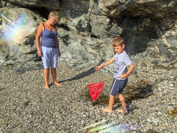 Boy standing on rock