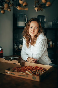 Portrait of young woman holding jigsaw pieces