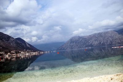 Scenic view of lake and mountains against sky