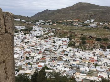 High angle view of townscape and mountains against sky