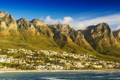 Scenic view of sea and mountains against sky