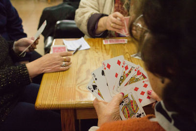 Women playing card game at table