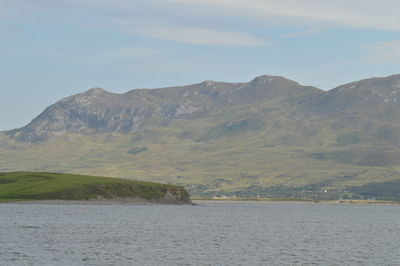 Scenic view of sea and mountains against sky