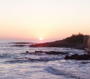 Scenic view of sea against clear sky during sunset