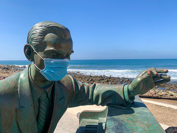 Man in sea against clear sky