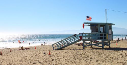 Lifeguard hut on beach against sky