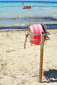 Red chairs on beach by sea