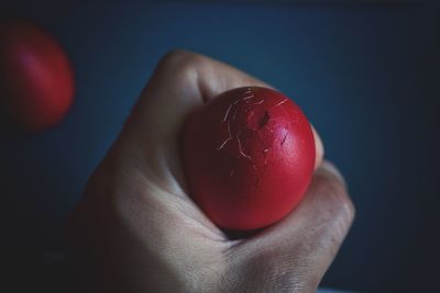 Close-up of hand holding over black background